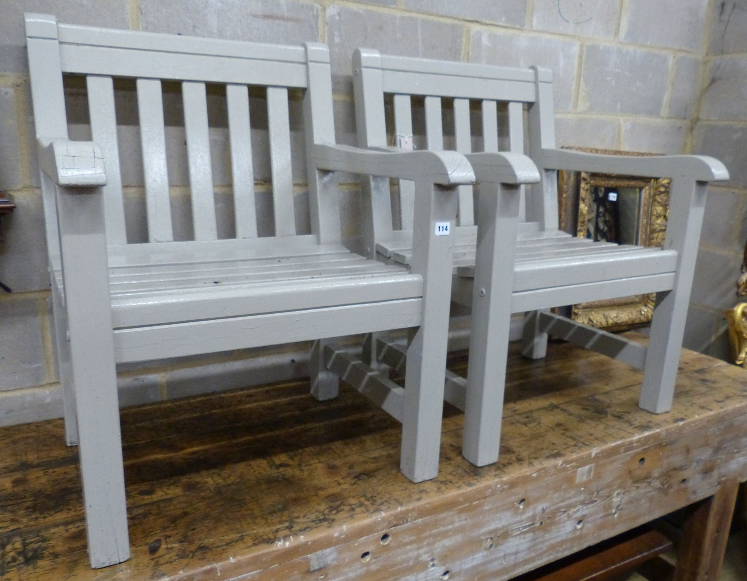 A pair of painted teak garden armchairs, W.65cm D.61cm H.88cm